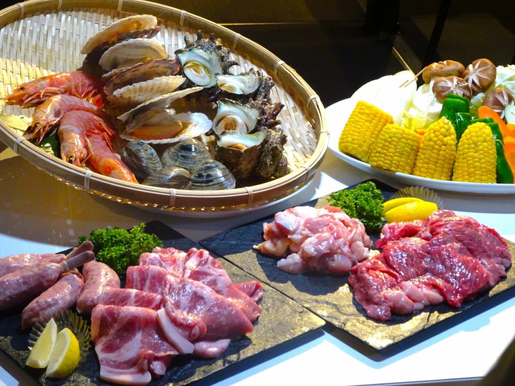 バーベキュー食材の肉、野菜、海鮮がテーブルに置かれている